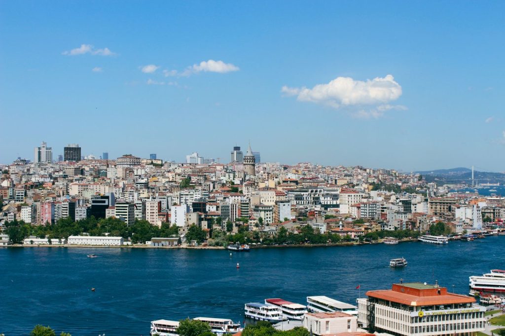A vibrant view of Istanbul's skyline with the Bosphorus in the foreground, showcasing historical architecture.